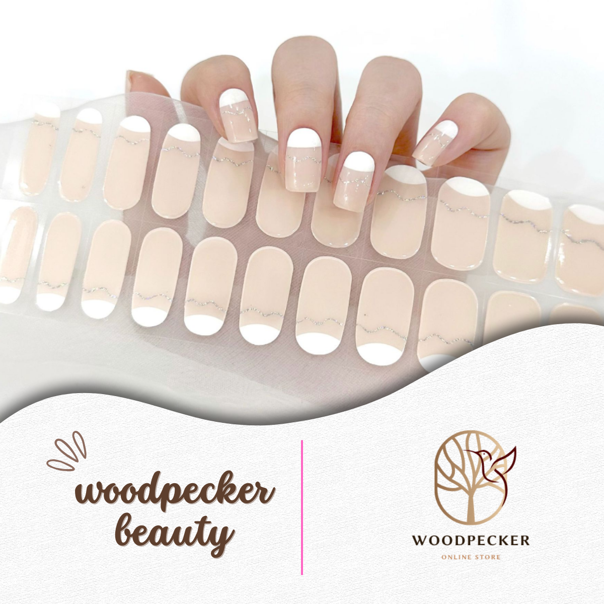 Hand with French nude gel nail stickers featuring white tips and fine gold glitter line – Woodpecker Beauty