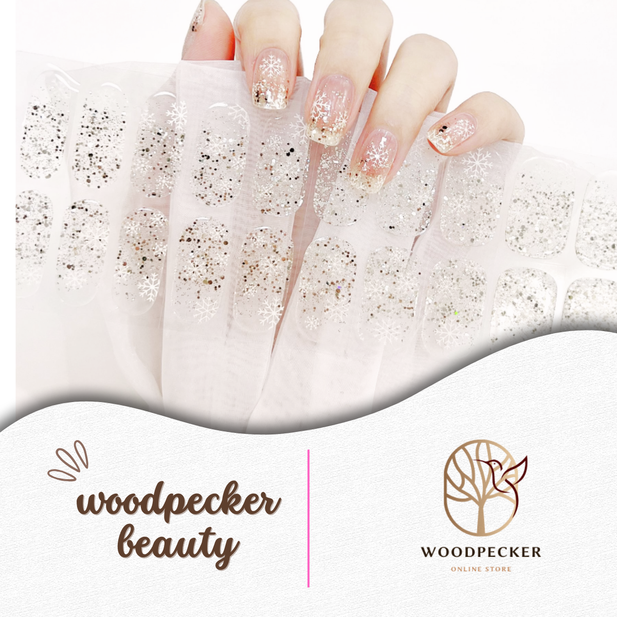 Clear gel nail stickers with silver glitter and white snowflake patterns from Woodpecker Beauty