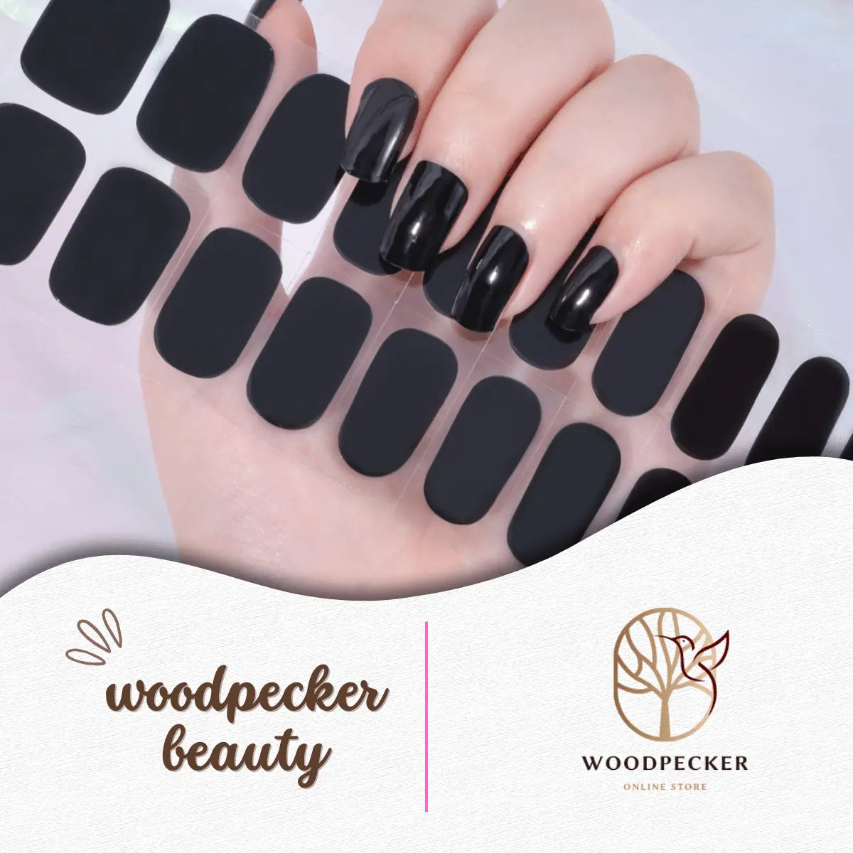 A sticker sheet of solid black semi-cured gel nail stickers next to a hand with applied nails