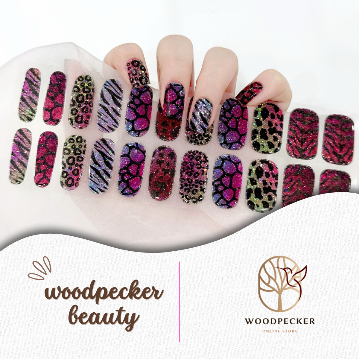 Hand with colorful glitter nail stickers featuring leopard and zebra patterns in red, purple, pink, and blue