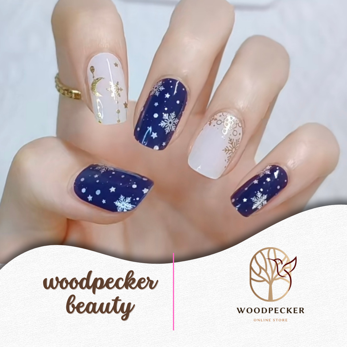 Navy and nude nail stickers featuring snowflakes, gold stars, and celestial designs with a winter theme.