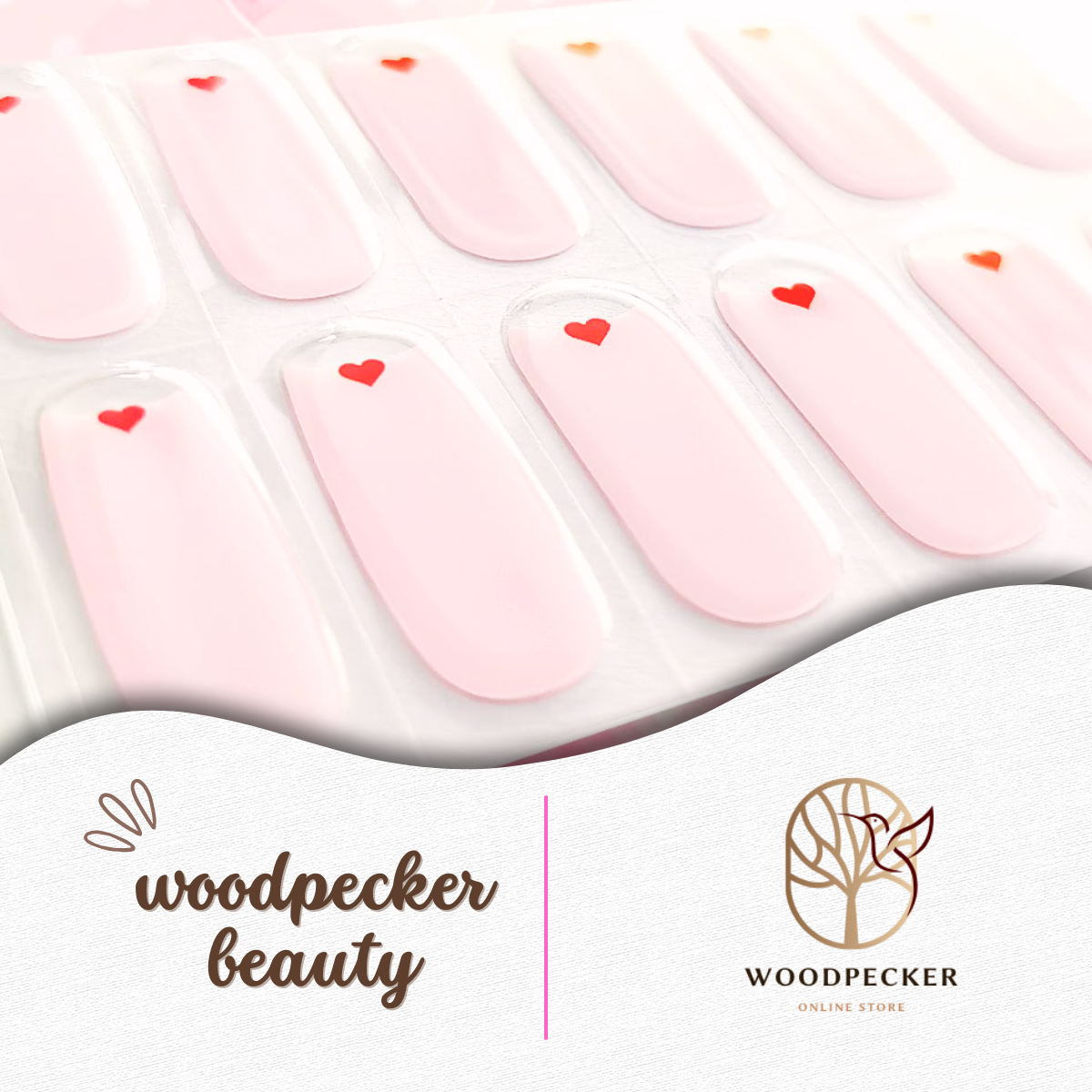 Close-up of pink gel nail wrap sheet with red heart designs