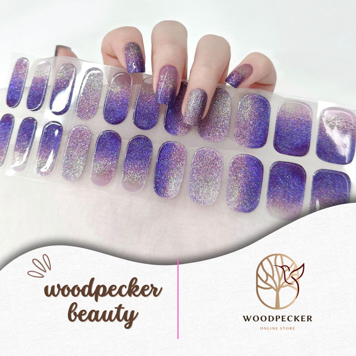 Hand with purple holographic glitter gel nail wraps and full matching sheet, UV lamp required