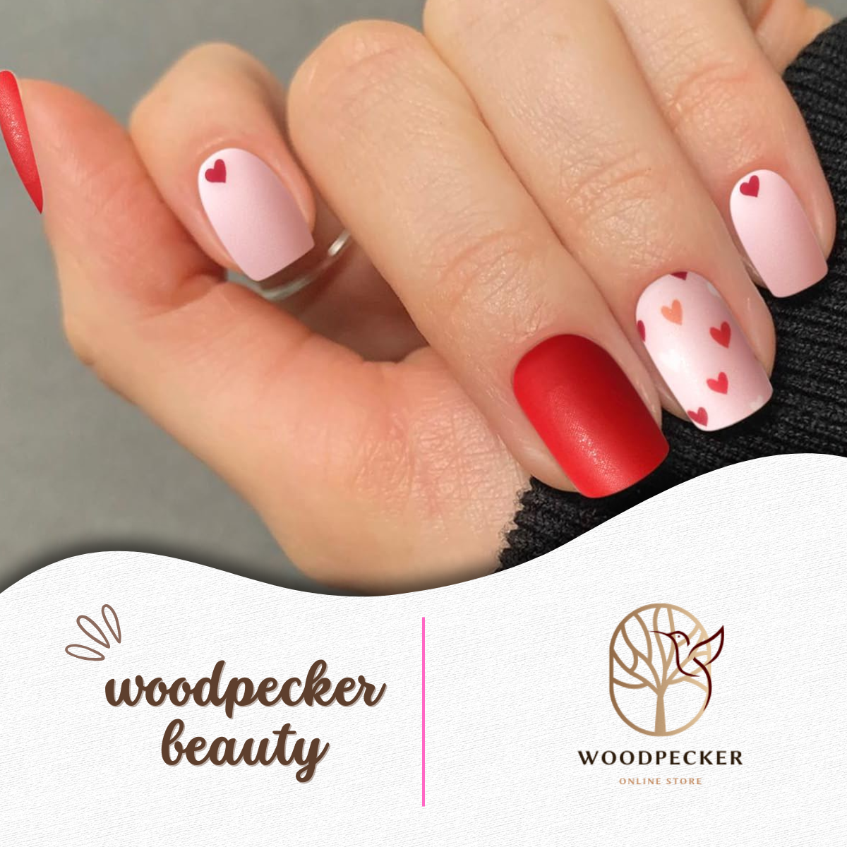 Hand showing applied red and pink nail wraps with mixed heart patterns