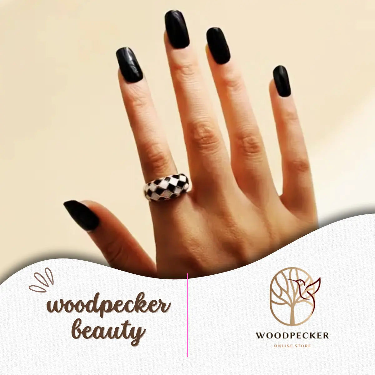 Hand with glossy black nail wraps and silver rings, minimalist and chic look
