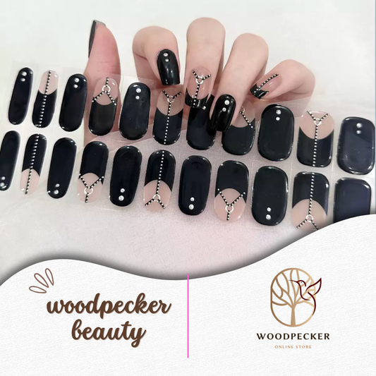 Glossy black gel nail stickers with silver zipper and studded details from Woodpecker Beauty
