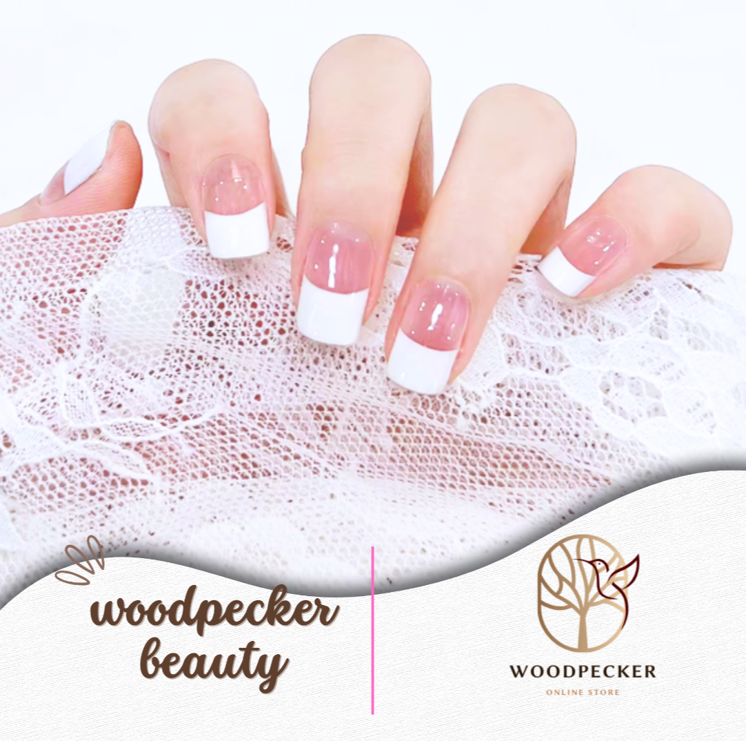 Hand with classic French tip nail stickers on a lace background