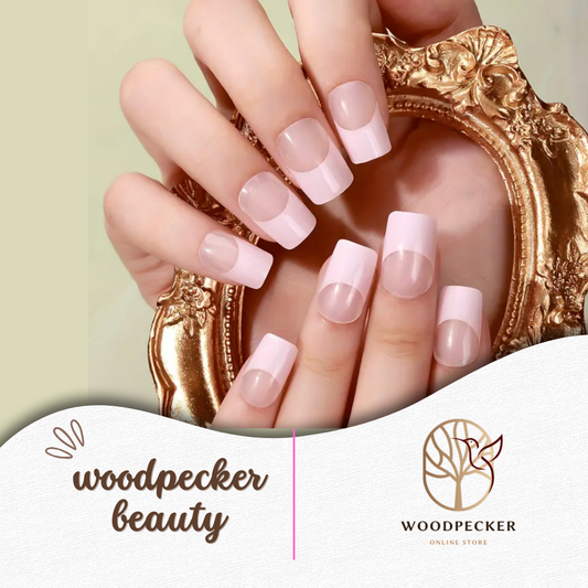 Hands holding a mirror, showcasing freshly applied pink French tip nail wraps