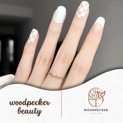 White gel nail stickers featuring checkered accent design with solid white nails from Woodpecker Beauty
