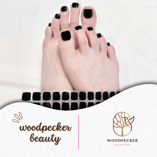 jet black gel toe nail stickers with high-gloss finish applied on toenails
