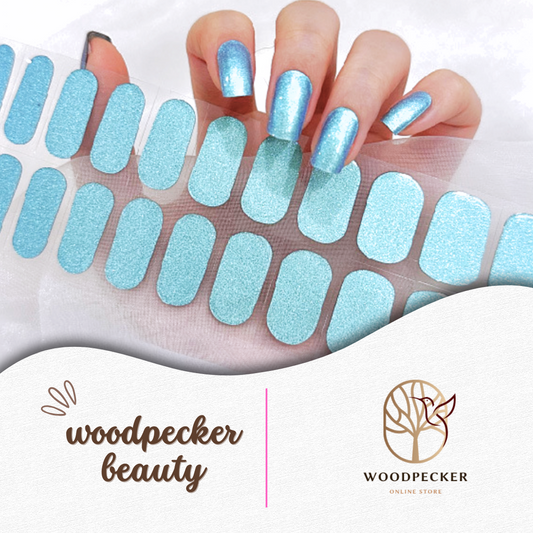  Shimmering ice blue nail wraps with a glossy finish, applied on long square-shaped nails