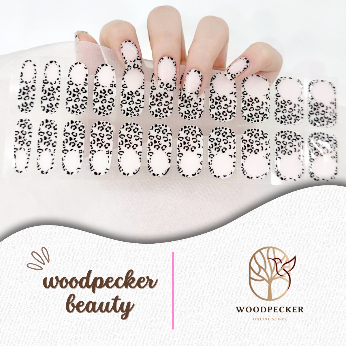 Hand with semi-transparent nude and black leopard print gel nail stickers from Woodpecker Beauty
