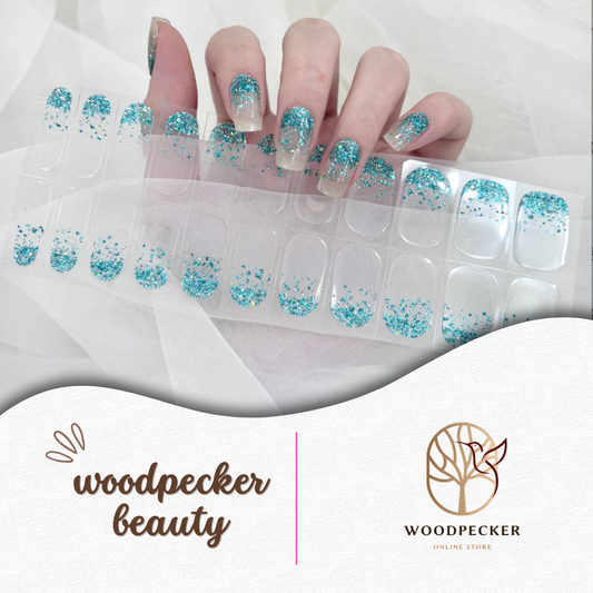 Clear gel nail stickers with turquoise blue glitter French tips from Woodpecker Beauty
