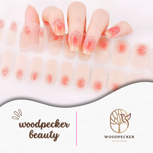 Clear semi-cured gel nail stickers with soft peachy pink blush and white heart swirl line art from Woodpecker Beauty
