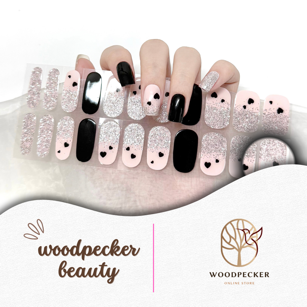 Nail art display with black, white, and pink designs on a white background, featuring Woodpecker Beauty branding.