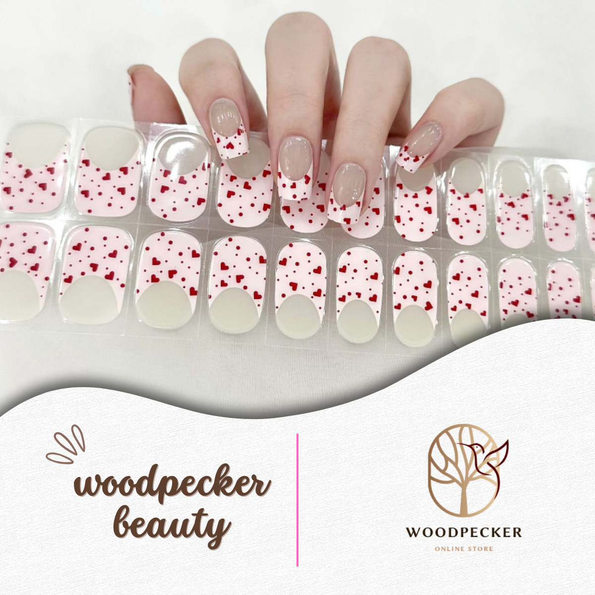 Pink French tip nail stickers with scattered red heart confetti design from Woodpecker Beauty
