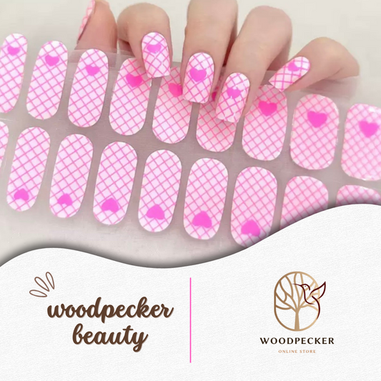 Pink plaid nail wraps with heart-shaped accents and glossy finish
