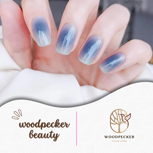 Hand with misty blue gradient nail wraps featuring a soft cat-eye shimmer 