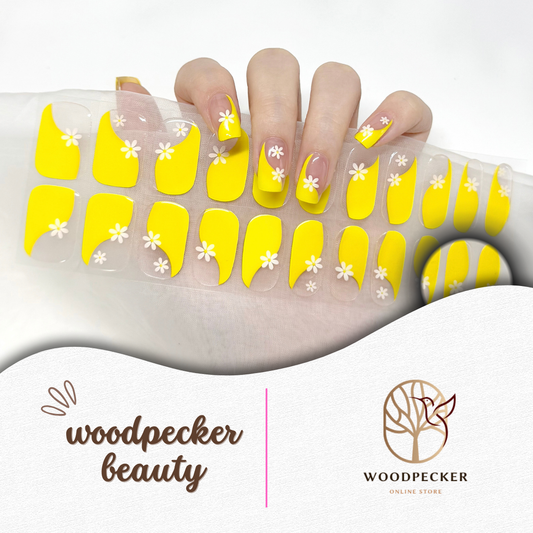Bright yellow semi-cured gel nail stickers with white daisy flower accents, styled on real hand and full sheet.
