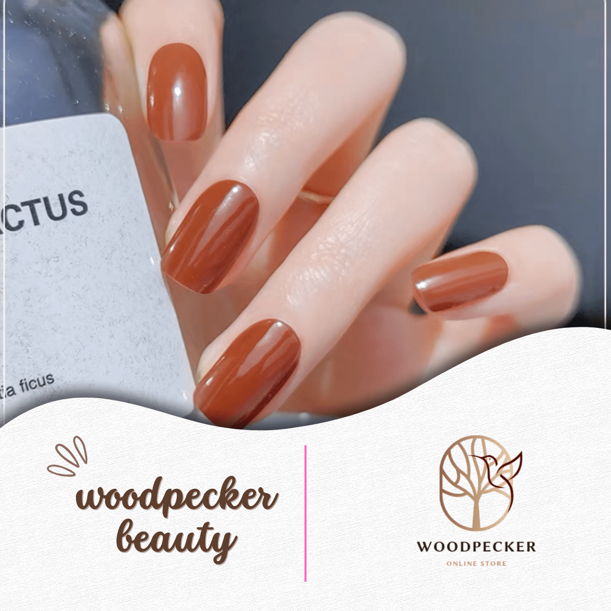 Hand with glossy caramel brown nail stickers holding a minimalist bottle.
