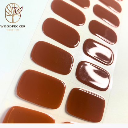Sheet of glossy caramel nude gel nail stickers with a smooth, even finish.
