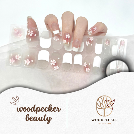 Cherry blossom semi-cured gel nail stickers featuring white French tips and soft pink floral accents, displayed on a hand and sticker sheet.
