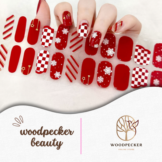Christmas nail stickers featuring red and white checker patterns, candy cane stripes, snowflakes, and Christmas tree accents on glossy red base.
