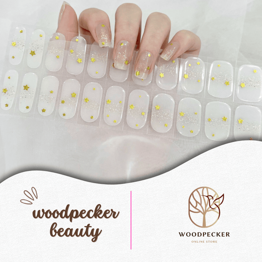 Transparent nail stickers with scattered gold star glitter for a delicate and airy design.
