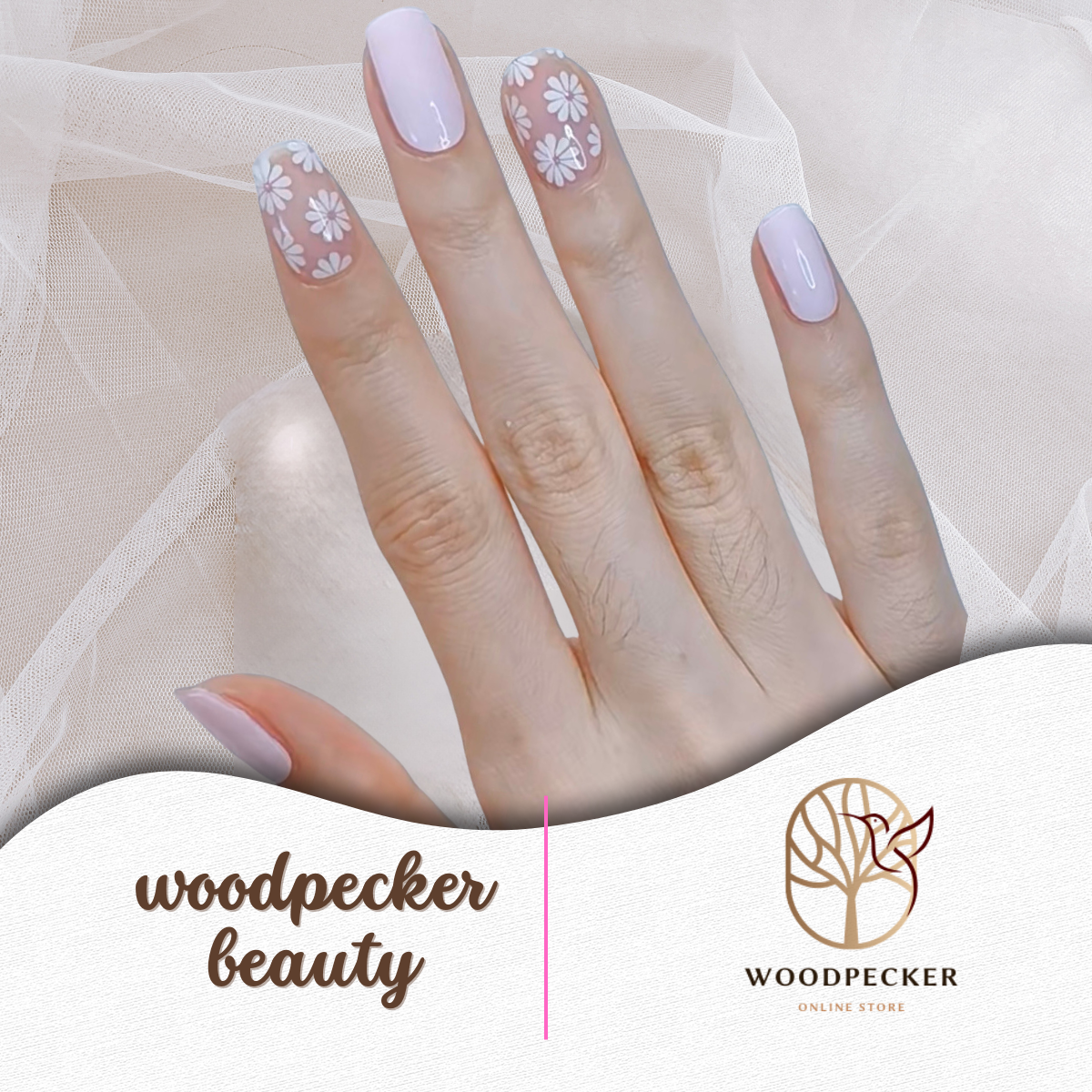 Hand with pastel purple and white daisy nail wraps, shown against a sheer fabric background.
