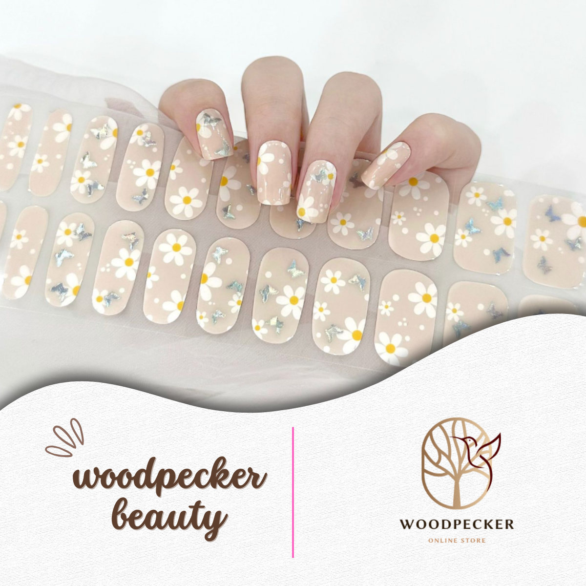 Hand with semi-cured gel nail wraps featuring white daisy flowers on a nude transparent base, UV lamp required
