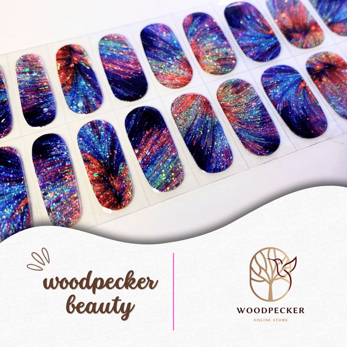 Flat lay of glitter nail stickers with firework-style bursts in deep blue, orange, and pink tones.
