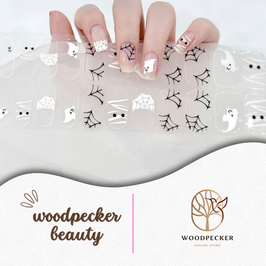 Cute ghost and spiderweb Halloween nail wraps on a clear base
