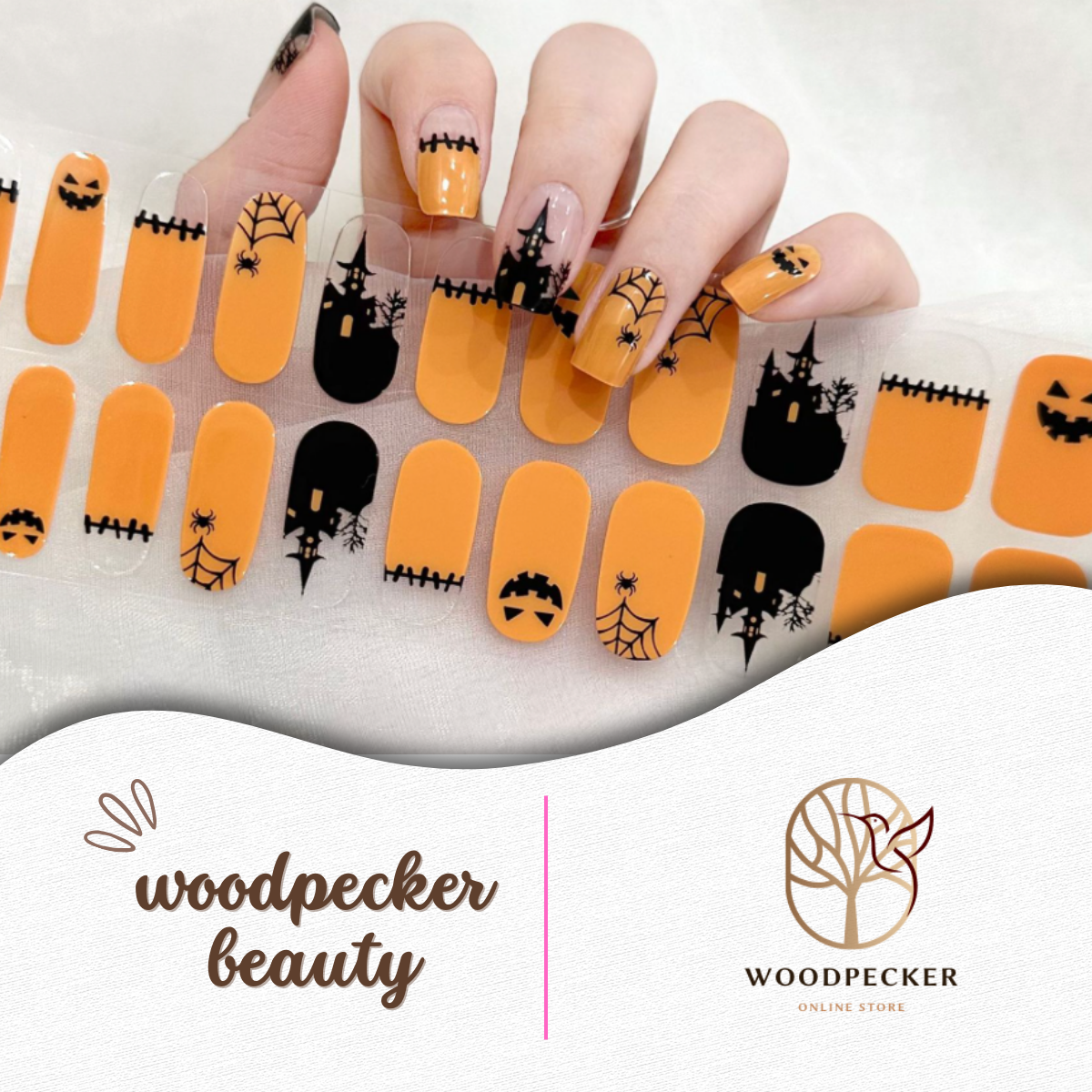 Halloween nail stickers with bright orange base and black spooky designs including jack-o’-lanterns, spiderwebs, and haunted trees.
