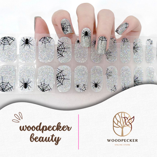 Semi-cured gel nail wraps with holographic glitter base and black spiderweb design; glow in the dark
