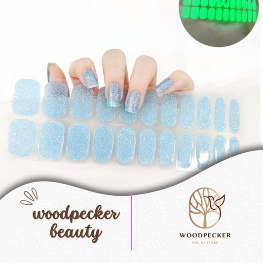 Semi-cured gel nail wraps in icy blue glitter with green glow-in-the-dark effect, UV lamp required
