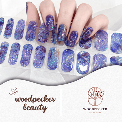 Purple and blue glitter nail stickers with silver flakes, inspired by a galaxy night sky.
