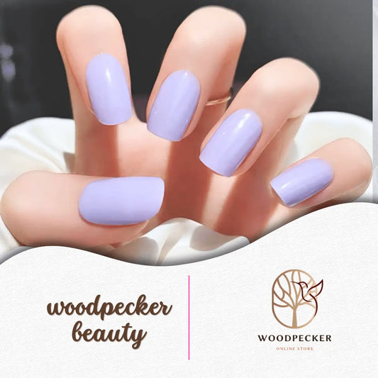 Glossy pastel purple nail stickers on hand with a soft, macaron-inspired finish.
