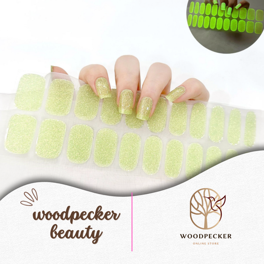 Semi-cured gel nail wraps in neon yellow glitter that glow in the dark, shown both in light and glowing effect, UV lamp required
