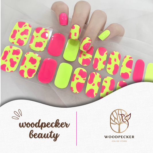 Neon yellow and hot pink nail wraps in a playful leopard print pattern, applied to a hand and displayed with the full sticker set.