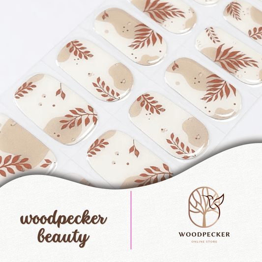 Beige and off-white nail stickers with abstract leaf patterns in warm rust tones.
