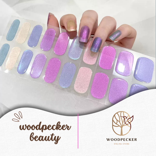 Hand with pastel pink, lavender, and blue semi-cured gel nail wraps with metallic glow effect, UV lamp required
