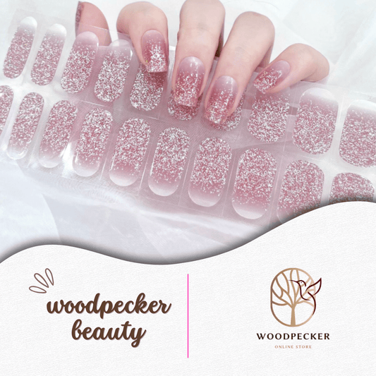 Nail stickers with pink glitter gradient fading from nude base to tips, creating a soft and sparkly ombré look.
