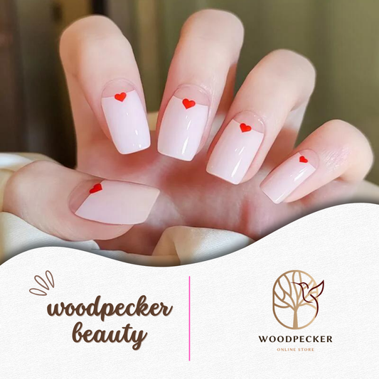 Manicure with soft pink nail wraps and tiny red hearts