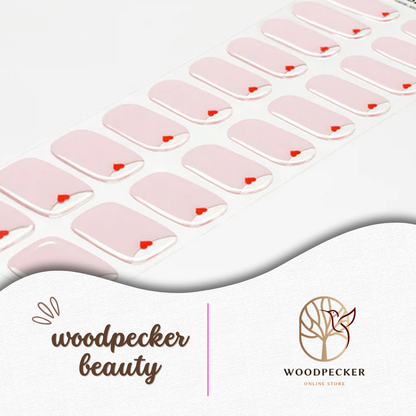 Full sheet of pink gradient nail wraps featuring minimal red hearts