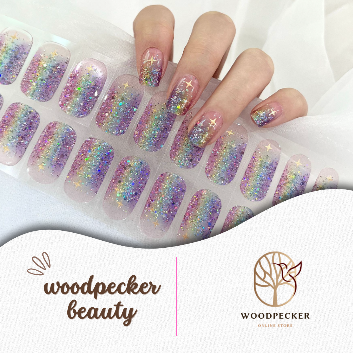 Hand with gradient rainbow glitter nail stickers featuring star details from Woodpecker Beauty
