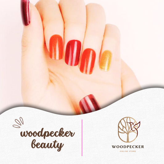Hand with red, orange, and gold cat-eye gel nail wraps in a gradient mix, UV lamp required