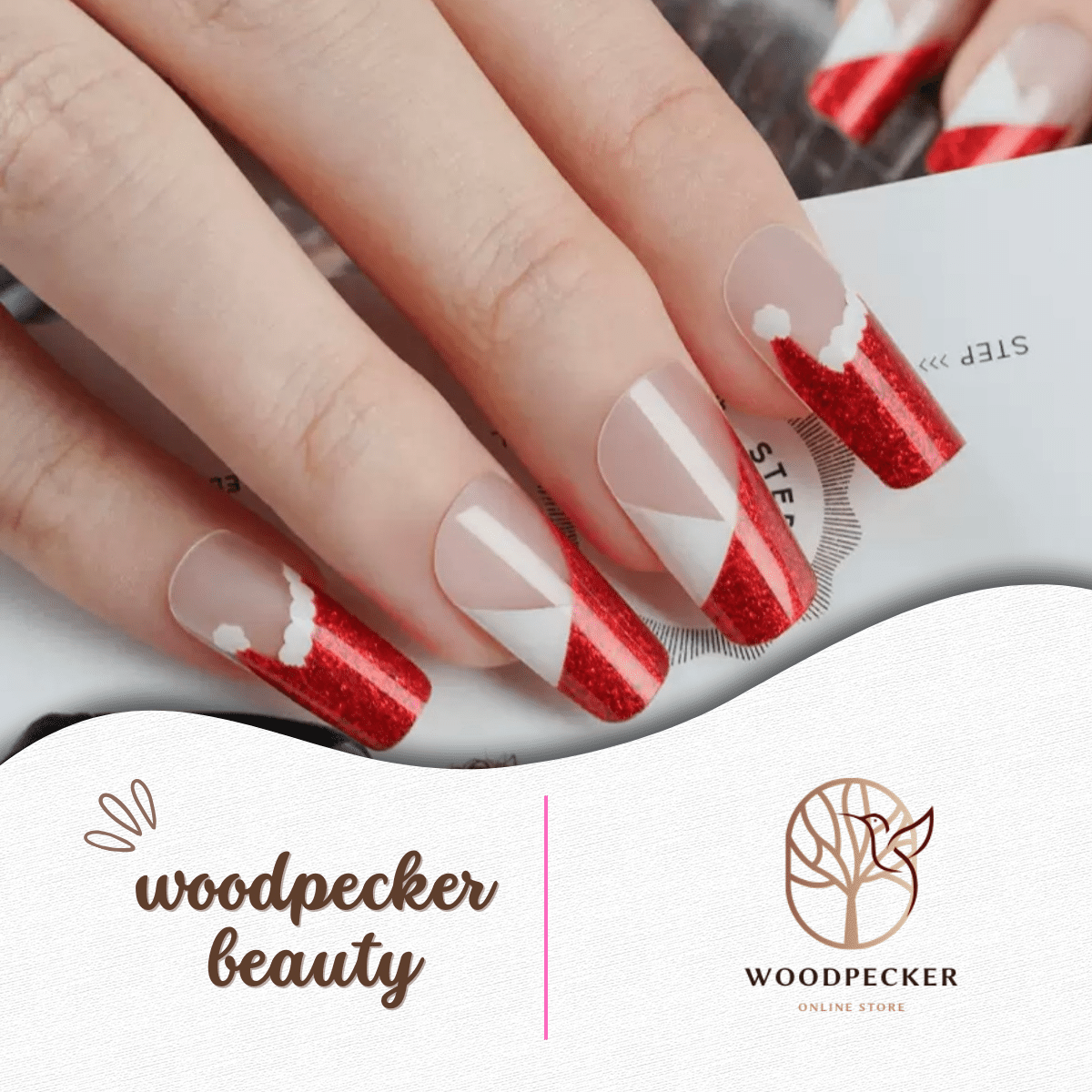 Nails styled with red glitter Santa hat design wraps, featuring curved white tops and negative space.
