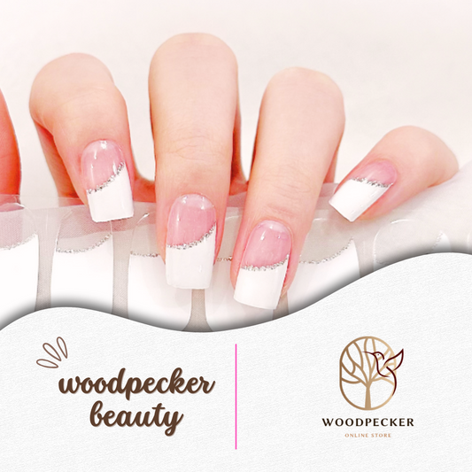 Elegant white French tip nail stickers with a diagonal silver glitter line on a clear pink base.
