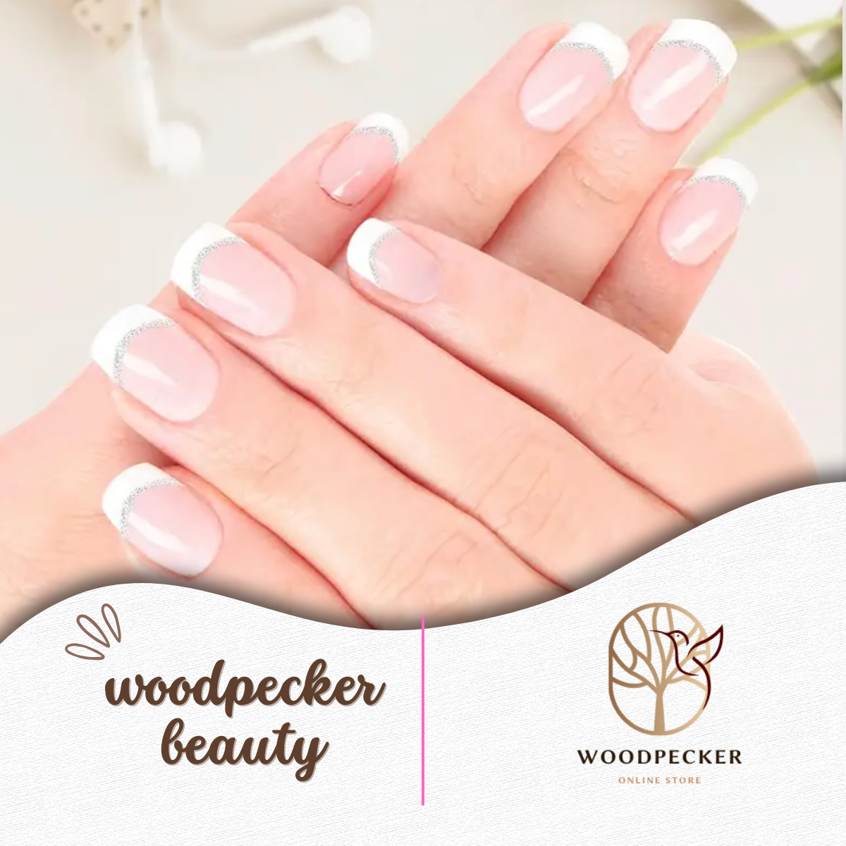 Hand holding pink nail wraps featuring a soft French tip style with metallic silver line detailing.
