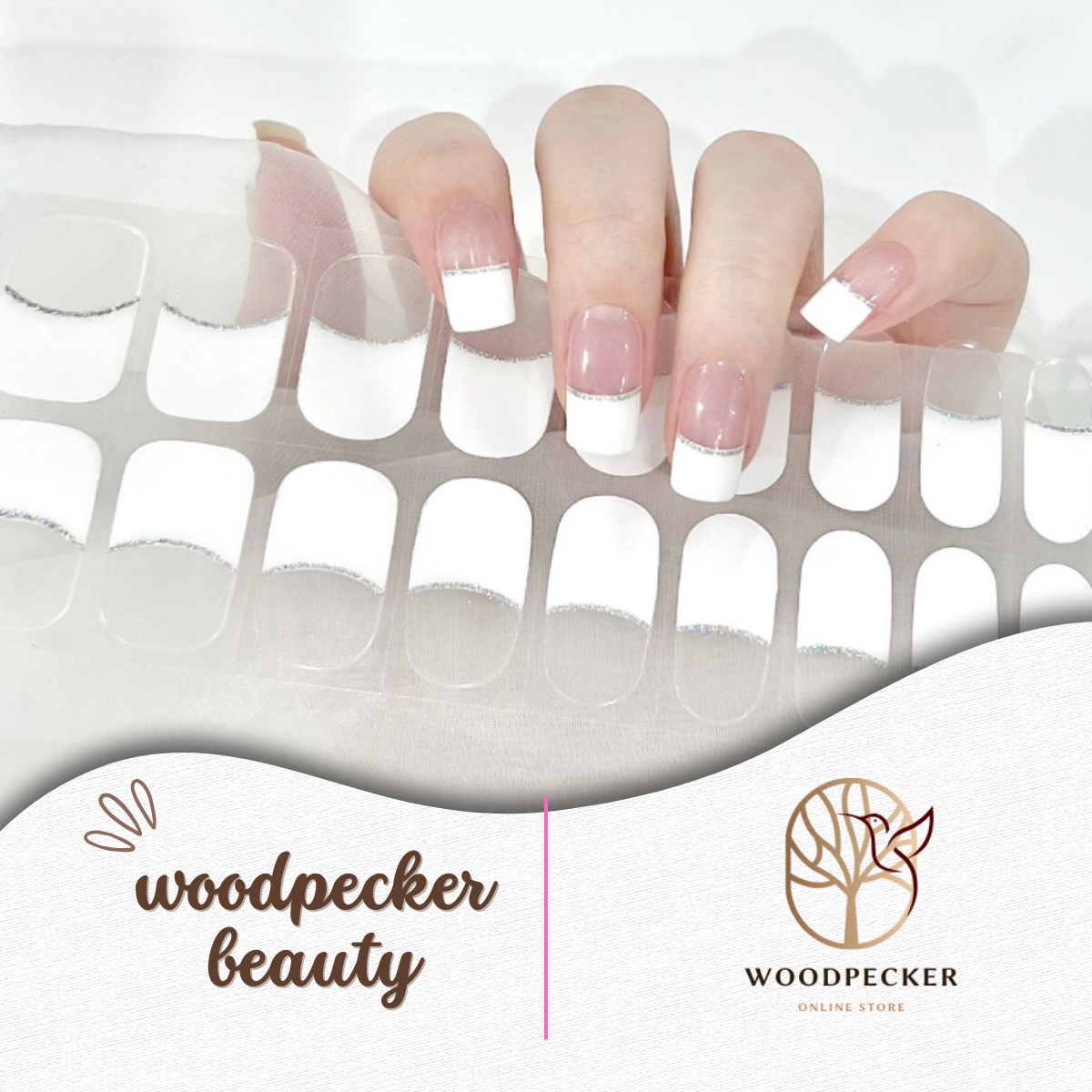 Flat lay of glossy pink nail wraps with silver stripe accents separating the base and tip.
